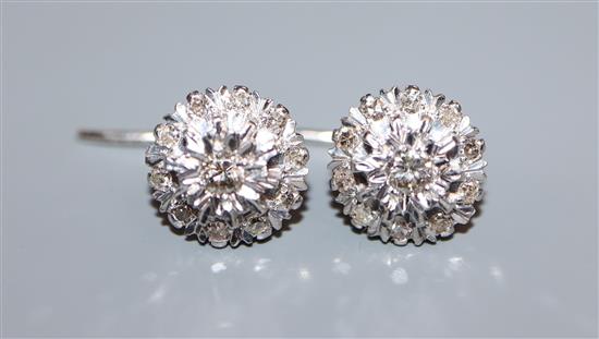 A pair of white gold and diamond illusion set cluster earrings, diameter 11.5mm